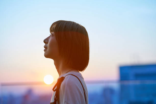 istock a young woman standing in the city during magic hour 2161693383