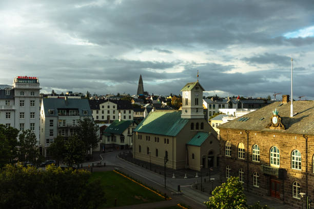 Wide shot of Reykjavik, Iceland, looking out on Austurvöllur, past Alþingishúsið, the parliament house, and Dómkirkjan cathedral and across the city towards Hallgrímskirkja. This still image is part of a series taken at different times of day from the same location; a time lapse is also available.
