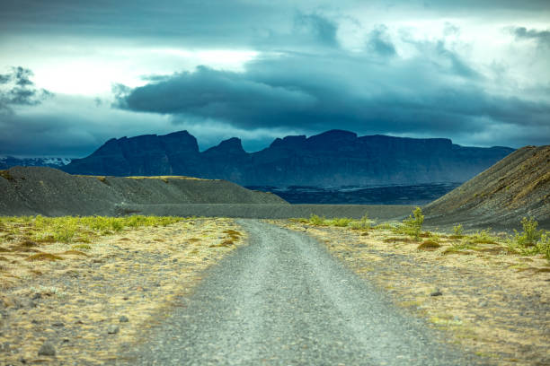 Snow capped peaks rise out of the clouds in Iceland's mountainous southern region