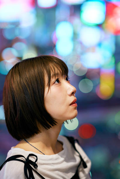 istock A young woman and downtown at night 2161694009
