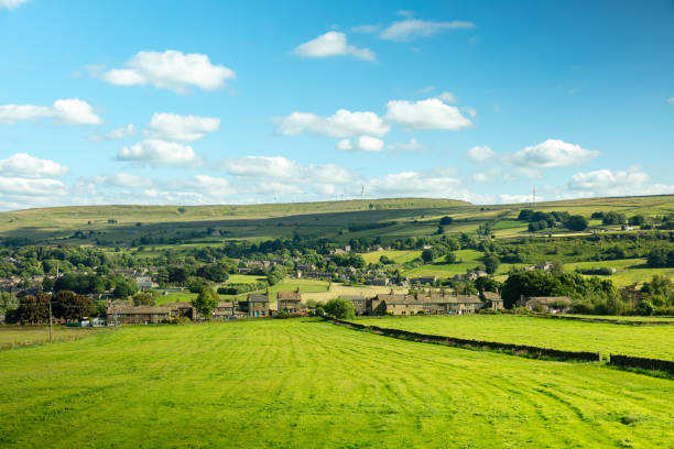 The village of Oxenhope and surrounding farmland in the Worth Valley in West Yorkshire, England on a sunny day in summer.