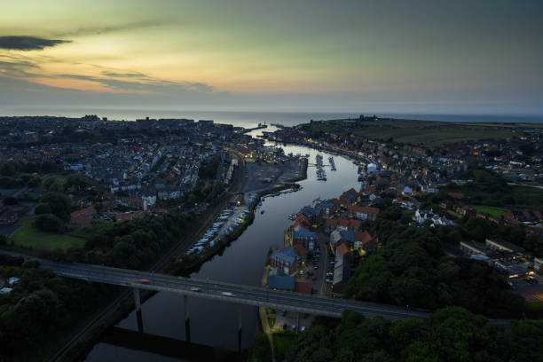 Aerial shot of Whitby, a town on the North Yorkshire coast in England famous for its ruined abbey, at sunset on a summer evening.