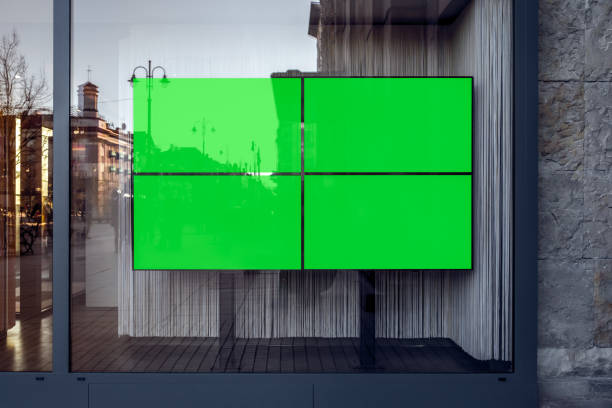 Four Widescreen TVs With Green Screen Mockups For Banners And Branding. Empty Store Showcase With Blank Advertising Billboards
