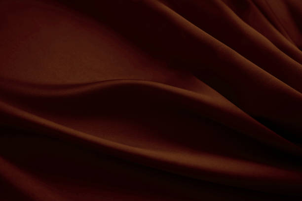 Black dark deep red brown mahogany abstract background. Silk satin velvet fabric. Elegant luxury rich. Curtain drapery fold line wave flow.