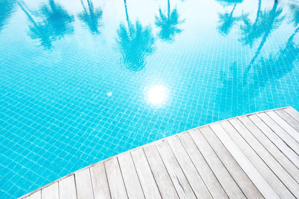 istock Boardwalk beside tropical resort swimming pool 2161698075