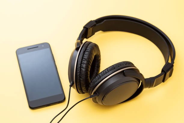 istock Headphones and smartphone on a yellow background 2161698909