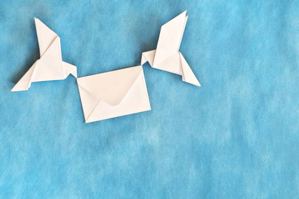 istock Two white dove carrying white envelope in blue background. Wedding invitation and message of peace concept. 2161699909