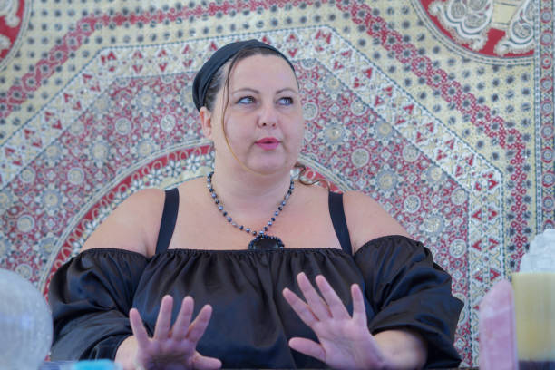 Gypsy woman holding crystals to her eyes making a happy face.