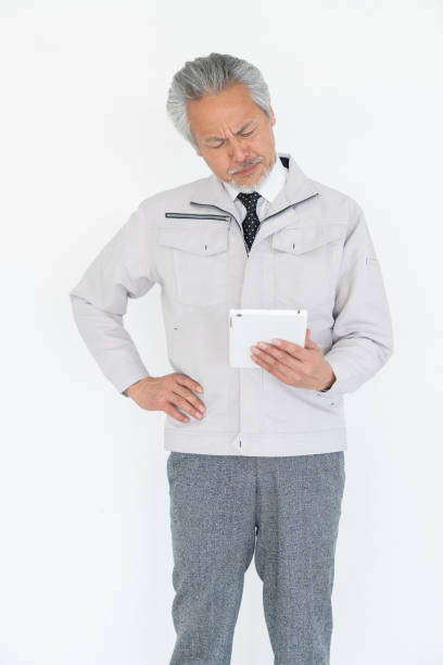 senior asian businessman who uses tablet computer, construction worker, trouble