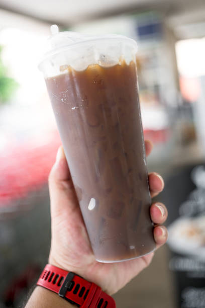 istock Take away plastic cup of iced black coffee in hand 2161702315