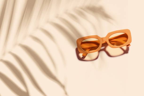 istock Trendy sunglasses with orange Frame on neutral beige background, copyspace, beach vibes, summertime mood concept, palm leaf shadow, summer fashion glasses. Minimal top view of eyeglasses 2161703988