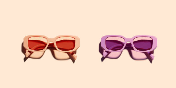 Trendy sunglasses with red pink and violet Frame on beige background, copyspace, beach vibes, summertime mood, sunlight shadow and glare, summer fashion glasses. Minimal top view of eyeglasses