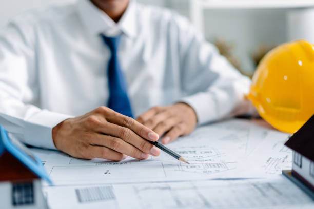 istock Architect working with house plans on a blueprint in the office, development low residence projects, design home custom of customer, build a housing estate. 2161705298