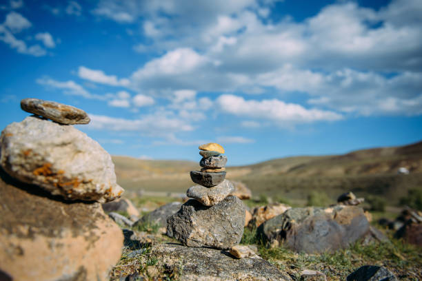 Zen balanced stones stack in high mountains. Buddhism place of power. Stone pyramid built by travelers.