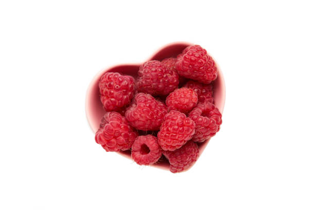 istock Raspberries heart shaped bowl isollated on white background. 2161708574