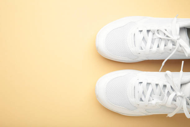 istock White sneakers on a beige background. Space for text 2161708691