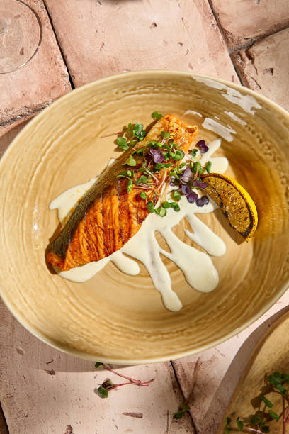 istock Salmon Steak with Cream Sauce on Beige Table in Sunlit Still Life Setting 2161710608