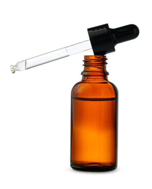 Dropper Bottle With Liquid Dropping on a White Background