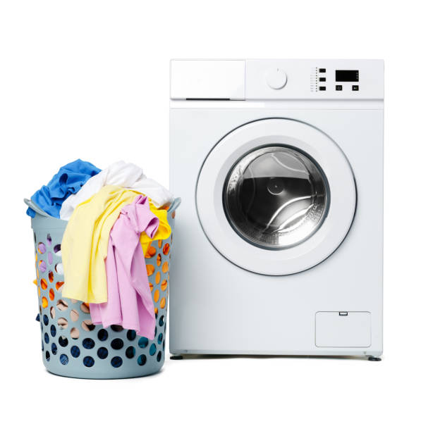 istock White Front Load Washing Machine and Laundry Basket 2161712223