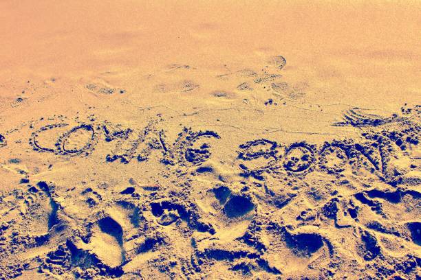 Coming Soon written on the sandy beach