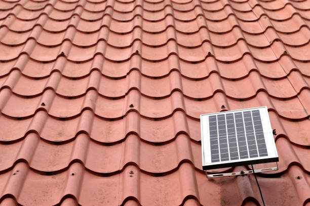istock single small solar cell panel on grunge red tile roof with copy space 2161712457