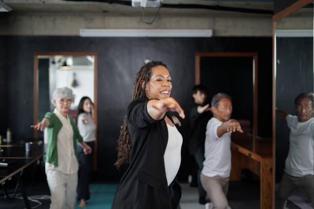 istock African ethnic yoga instructor practicing office yoga and health exercise with multi ethnic business people in modern office 2161712545