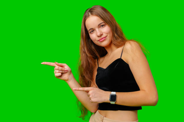istock Woman Pointing at Something on Green Screen 2161712616