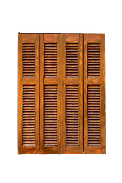 Closed wooden louvered shutters isolated on a white