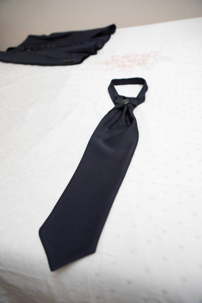 Blue printed tie with red details, on a rustic wooden background