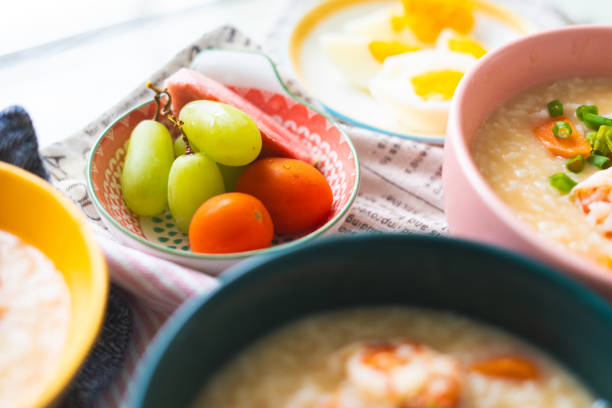 A nutritious breakfast featuring perfectly boiled eggs, served alongside a vibrant assortment of fresh fruits including grapes and cherry tomatoes. The simplicity of the dish highlights the balance of protein and vitamins, making it an ideal start to the day. This home-prepared meal showcases the beauty of whole, unprocessed foods, arranged in a visually appealing manner with colorful ceramic bowls, emphasizing a healthy and delicious morning routine.