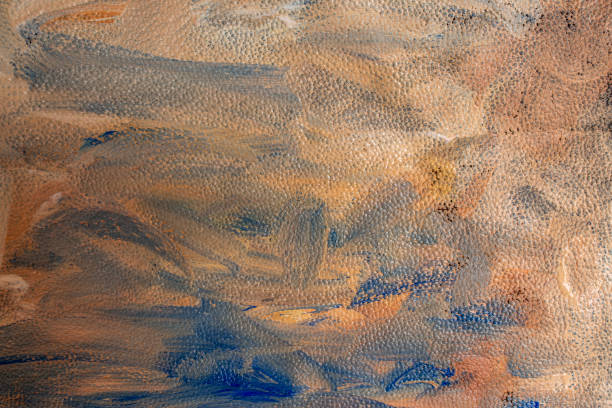 Wavy acrylic paint , blue, orange and beige smudges on leather texture