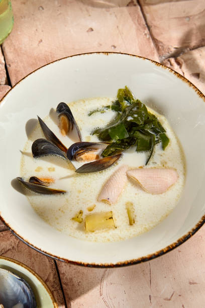 istock Authentic Creamy Seafood Soup in Rustic Sunlit Setting 2161714740