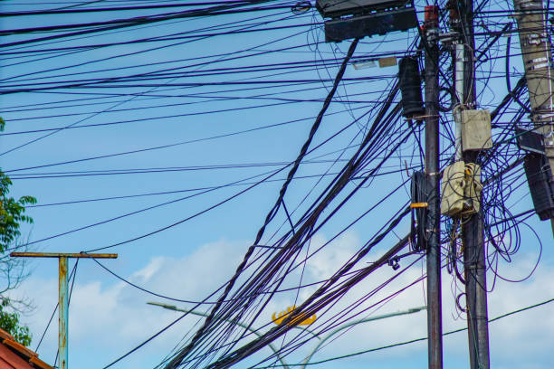 Electric and telephone cables tangle on electric pole