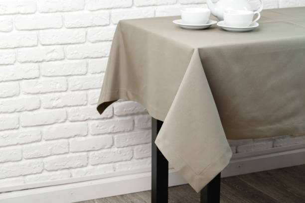 istock Beige Tablecloth on White Brick Wall With Teacups and Teapot 2161715553