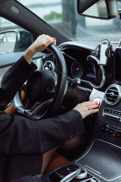 istock woman presses start stop button in car 2161719912