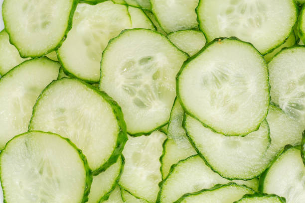 Fresh cucumbers cut into circles, top view close-up