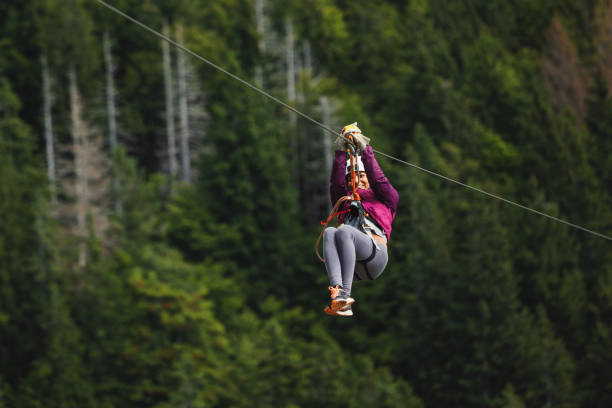 istock Female Adventurer Experiencing Zipline in Forest 2161723962