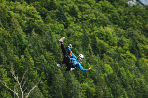 istock Male Adventurer Enjoying Zipline Activity in Forest 2161723967