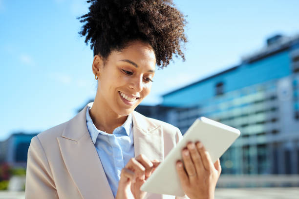 istock Confident Businesswoman Using Tablet in Urban Setting, Smiling 2161725329