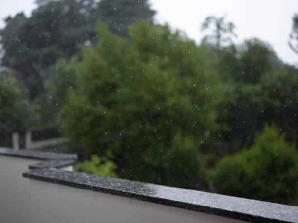 raindrops on the windowsill of a balcony