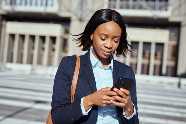 istock Confident Black Businesswoman Using Smartphone Outdoors in Urban Setting 2161727182