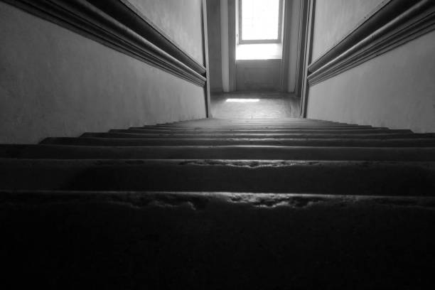 istock Dark Staircase Leading to a Bright Window - Architectural Design Concept for Dramatic Lighting 2161728627