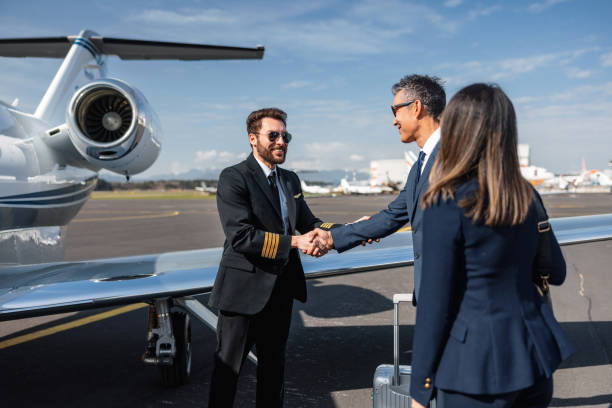 istock Business Executives Handshake by Private Jet on Tarmac 2161728681