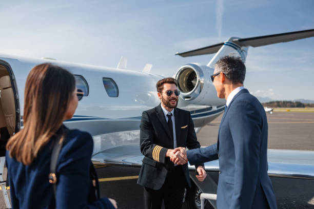 istock Business Executives Shaking Hands by Private Jet 2161728685