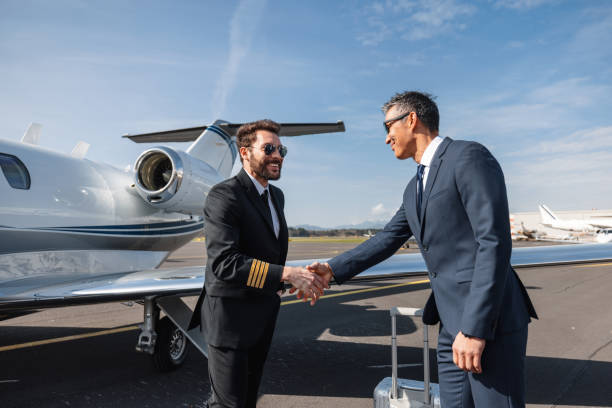 istock Pilot Greeting Businessman by Private Jet on Tarmac 2161728708