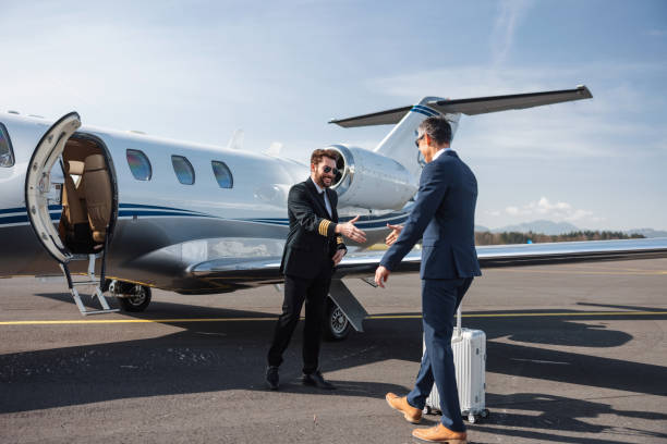istock Businessman Greeted by Pilot at Private Jet Before Departure 2161728716