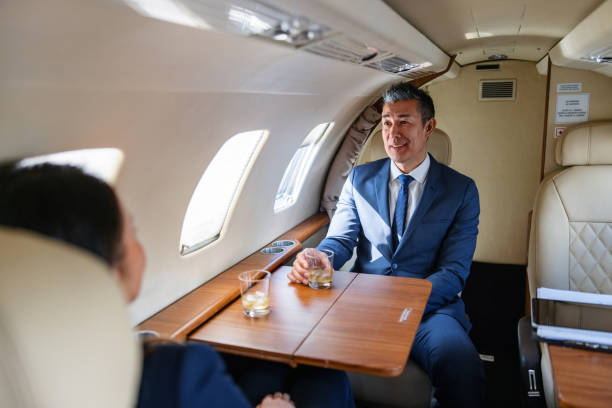 istock Two Businesspeople Celebrating Success on a Private Jet 2161728733