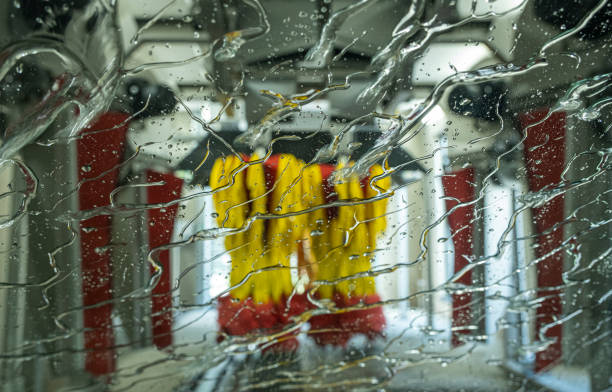 Car driving through an automatic car wash. Windscreen view from inside. Abstract wet windscreen background.