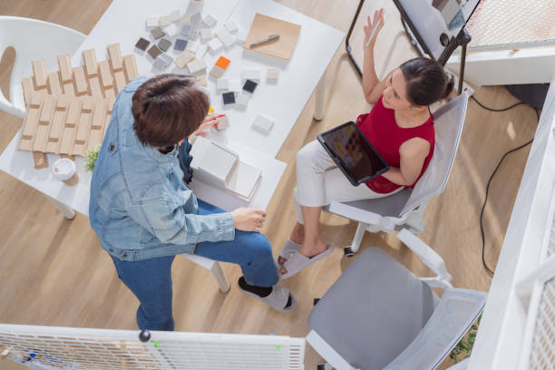 Meeting in a modern architectural office asian architect and interior designer working creative space planing design discuss brainstorm ideas sharing together Architect Team working best solution