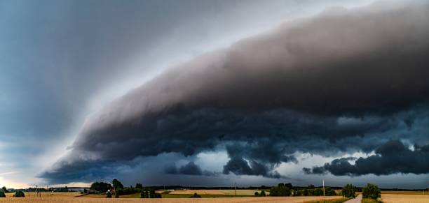istock WEATHER - Panoramic View of Dramatic Dark Rain Clouds over Fields and Country Road. Shelf Cloud, Supercell, Cyclone, Storm, Lithuania 2161732886